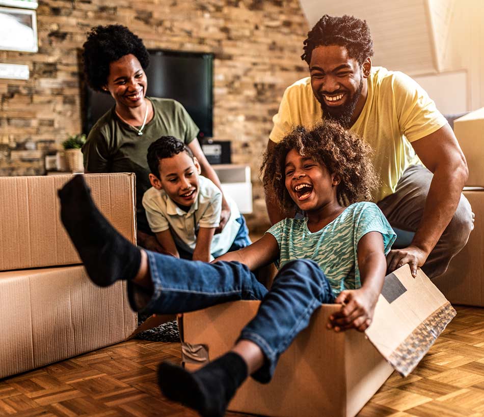 Family playing with their moving boxes.