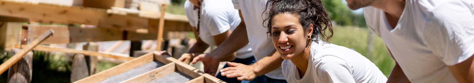 People helping build a community project.